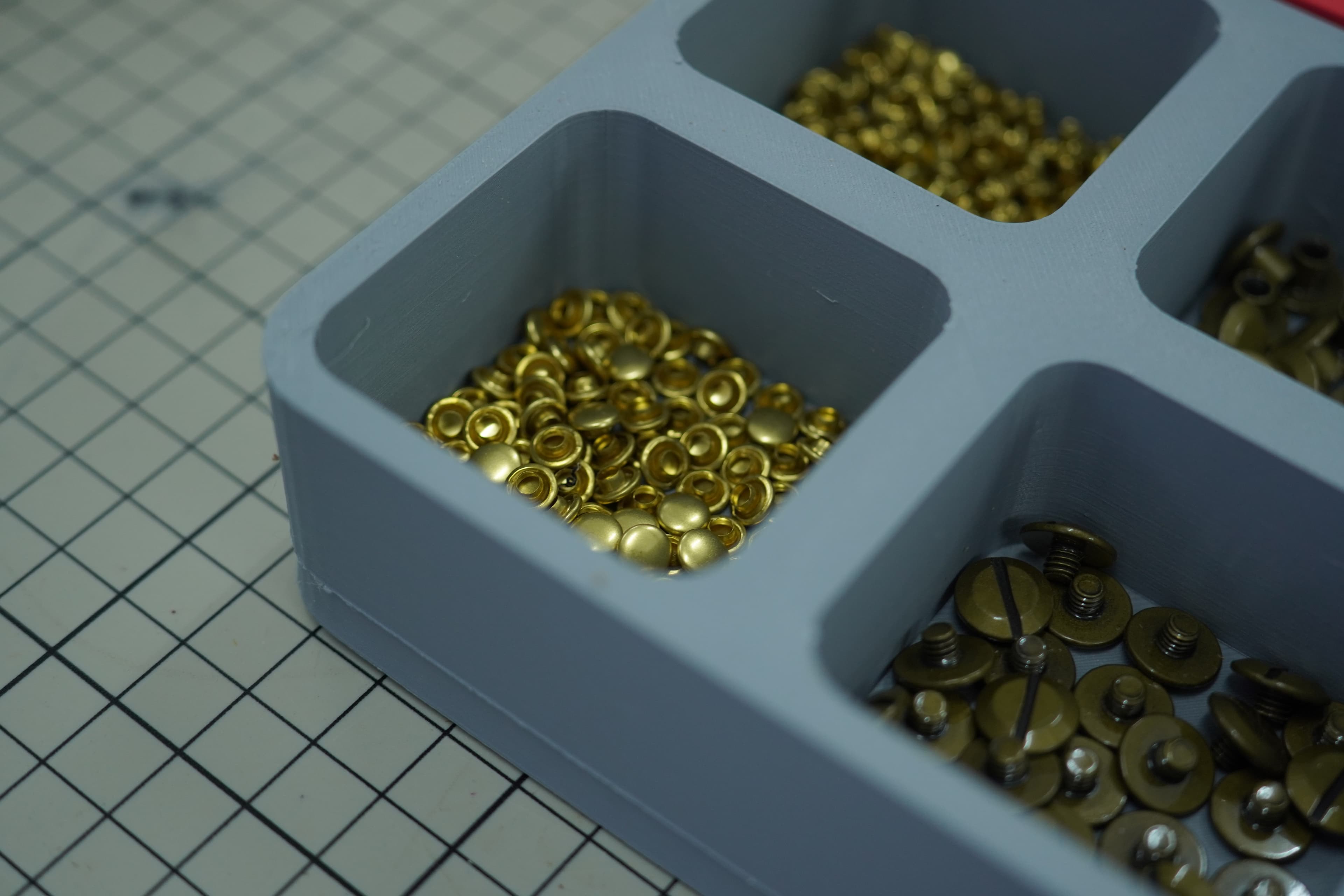 Hardware parts tray with brass rivets and screws